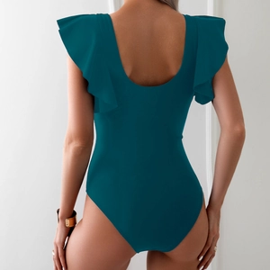 Detail view of one-piece dark green swimsuit with ruffled shoulders and open back
