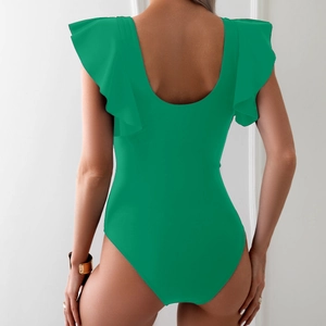 Detail of emerald green one-piece swimsuit featuring double ruffled cap sleeves and open back