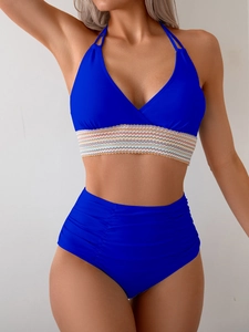 Detail of dark blue halter bikini with colorful wavy trim and ruched high waist bottoms