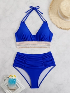 Flat lay of blue two-piece high waisted bikini with stylish side ruched details and sun hat