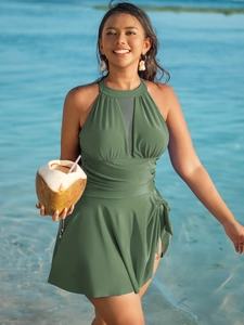 Detail of dark green halter swimdress with mesh V-neckline and tummy control ruching