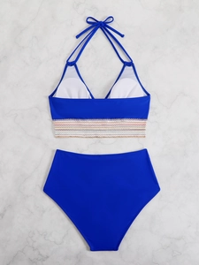 Detail of blue halter bikini top featuring colorful striped elastic band and white pads