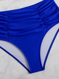 Detail of royal blue high-waisted bikini bottoms with slimming ruched texture design