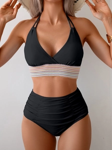 Close-up of black bikini top with colorful wavy crochet band and high-waist ruched bottoms
