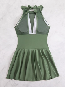 Detailed top view of dark green plus size swim dress with mesh halter neck and pleated skirt