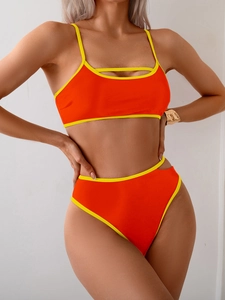Detail of two-piece orange and yellow bikini set featuring cutout side and top details
