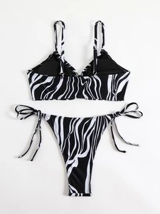 Flat lay of zebra print bikini set featuring tie-side bottoms and triangle top