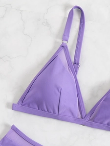 Detail shot of purple triangle bikini top featuring fine mesh texture and metal rings