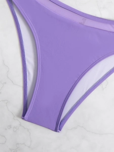 Detail showing lavender high-waist bikini bottoms with mesh panels on marble background