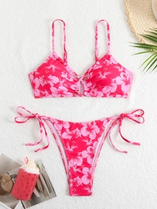Flat lay of floral pink bikini with center ring detail and side-tie high-cut bottoms