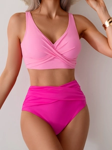Close-up of pink wrap V-neck bikini top and high-waisted ruched bottoms set for women
