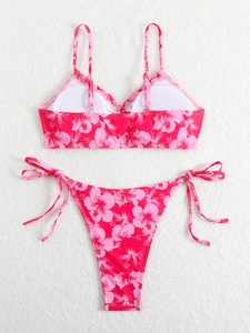 Detailed flat lay of pink floral hibiscus bikini with side-tie bottoms and removable pads