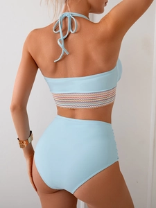 Rear view of light blue two-piece high-waisted bikini with colorful wavy trim and ruching