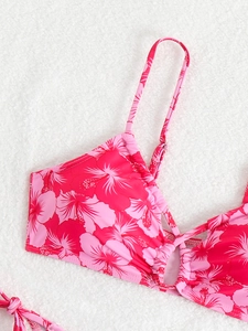 Close-up of pink hibiscus floral bikini top with adjustable straps and ruched detailing