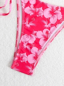 Detail of floral hibiscus print bikini bottom in vibrant pink with high-cut design