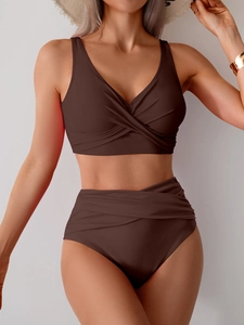 Detail of a dark brown high-waisted bikini set with a cross-front design and V-neckline