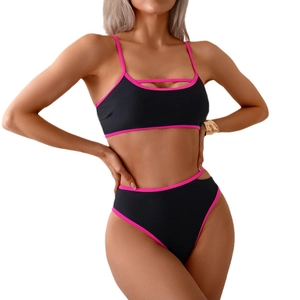 Two-piece black bikini with neon pink trim featuring cutout details and high waist