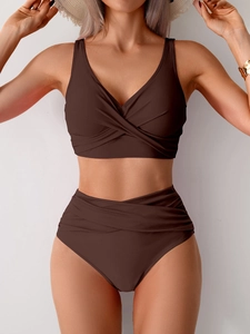 Detail view of chocolate brown high waisted bikini set with cross-over pleated design