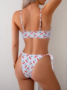 Close-up of the cherry print bikini set with side-tie straps on the back of the swimsuit