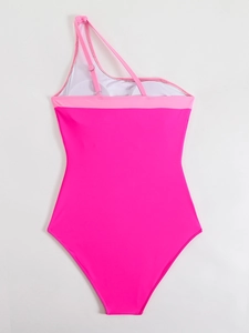 Detail of pink one-shoulder swimsuit with adjustable strap and contrast color trim