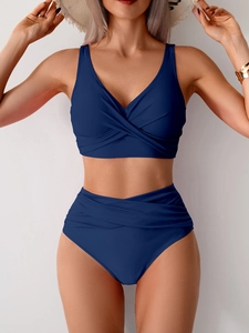 Detail of high waisted bikini set with v-neck top and stylish cross twist front design