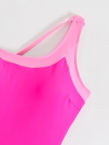 Close-up of pink patchwork swimwear fabric with precise stitching and elastic textures
