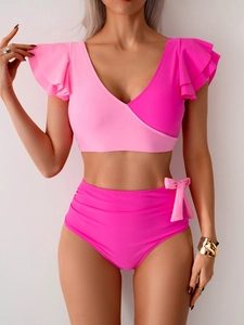 Detail of pink V-neck bikini top with ruffled sleeves and high-waisted bow bottoms