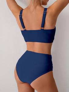 Detail view of dark blue high-waisted bikini set with silver metal back clasp and side ruching