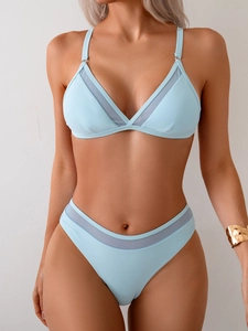 Detail of light blue bikini featuring mesh splicing and high-cut elastic fabric design
