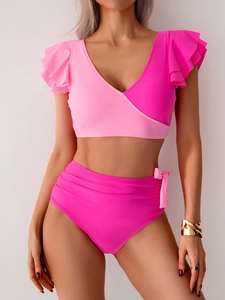Detail of pink two-piece bikini featuring ruffled shoulders and a side-tie high-waist bottom