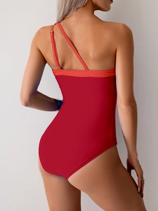 Detailed back view of a red one-shoulder swimsuit with asymmetrical strap design