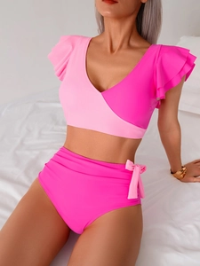 Detail of pink high-waisted bikini with ruffled sleeves and side decorative bow knots