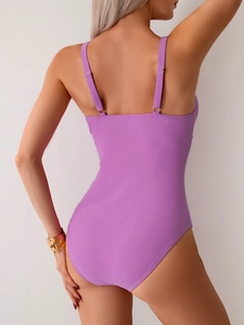 Detail view of purple one-piece swimsuit featuring adjustable thin straps and back design