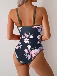 Close-up of floral print one-piece swimsuit with adjustable straps and open back detail