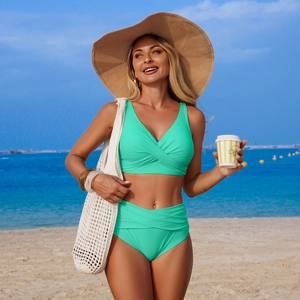 Detail of high-waist mint green bikini with cross-pleated V-neck and slimming texture