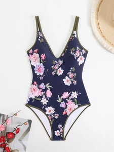 Detailed flat lay of floral one-piece swimsuit with V-neck and olive green straps