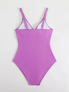 Detail of purple one-piece swimsuit featuring adjustable thin straps and silver hardware