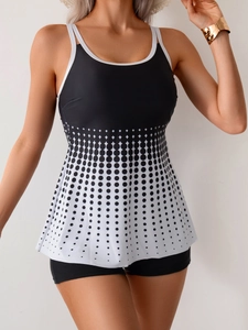 Detail of two-piece tankini set featuring black and white polka dot pattern and boy shorts