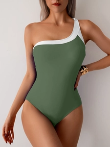 Detail of one-shoulder olive green swimsuit with white trim and metal shoulder ring