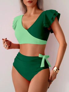 Close-up of high-waisted bikini bottoms with decorative light green side bows