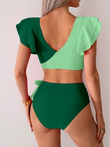 Back view of high-waisted bikini with green ruffle sleeve top and knotted swimsuit bottom