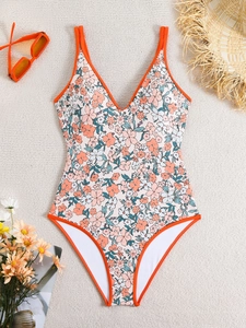 Detailed view of floral one-piece swimsuit with V-neckline and orange spaghetti straps
