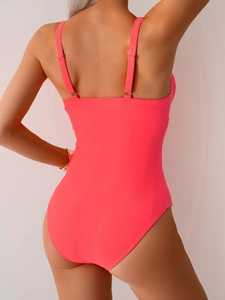 Rear view of neon pink one-piece swimsuit featuring adjustable straps and a low back cut