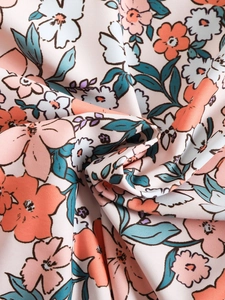 Detailed macro shot of floral print fabric showing texture and soft pastel pattern