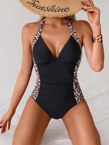 Detail of sexy deep V halter swimsuit with leopard print panels and ruched tummy control