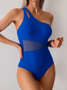 One-piece cobalt blue swimsuit with one-shoulder cutout and side mesh panel detail