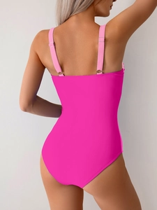 Close-up of pink one-piece swimsuit with U-shaped open back and adjustable straps
