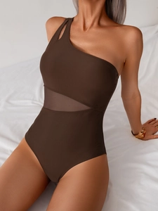 Detail of coffee brown one-shoulder swimsuit featuring mesh inserts and sexy cut-out design
