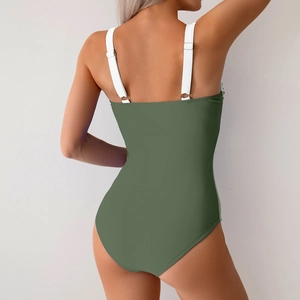 Detail of dark green one-piece swimsuit with white adjustable straps and open back design