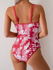 Detail of red one-piece swimsuit with tropical floral print and adjustable straps